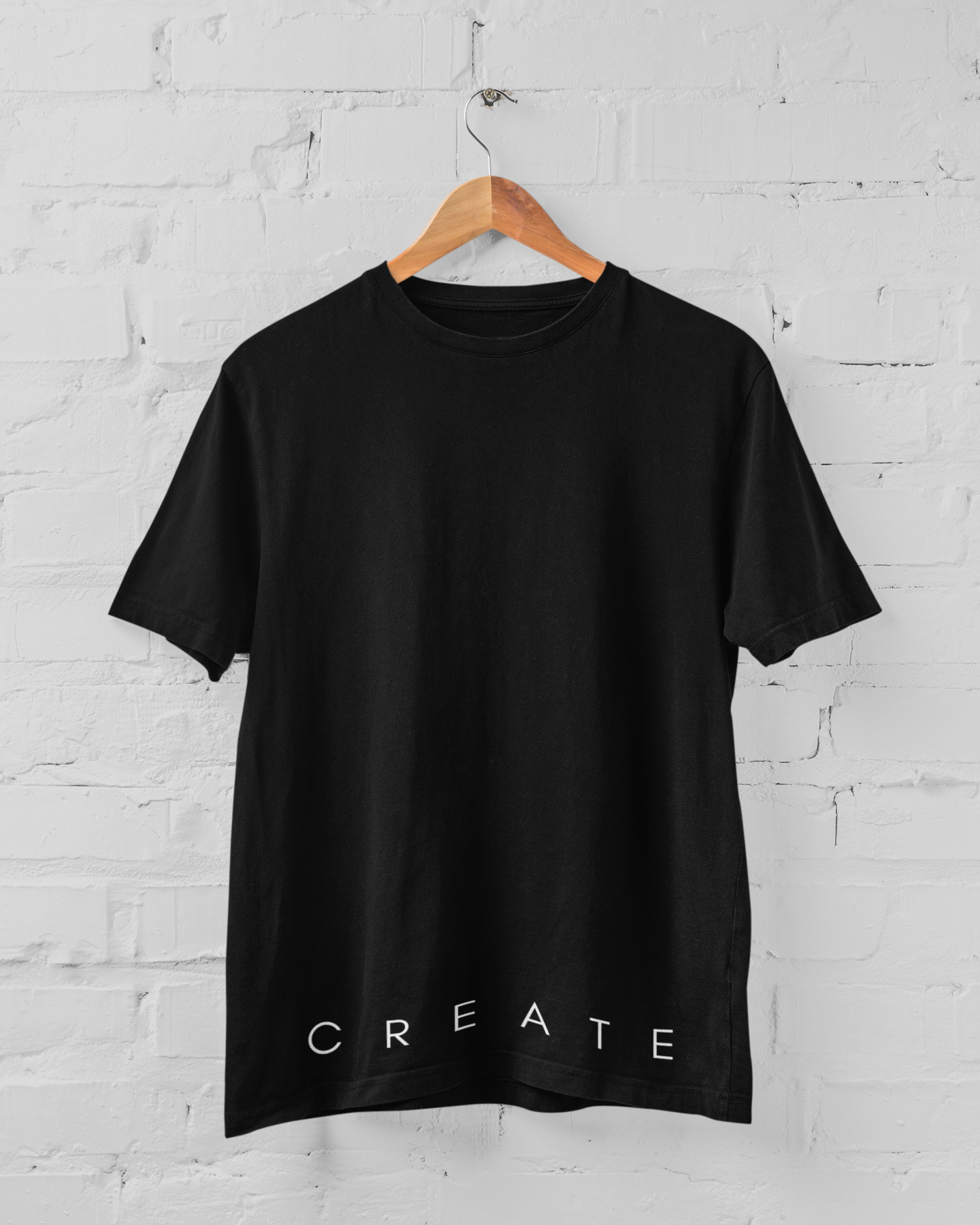 C R E A T E unisex t-shirt in various colors, showcasing its stylish fitted sleeves and durable fabric.